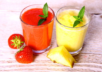 Strawberry, pineapple smoothie in glass, mint, slice pinapple