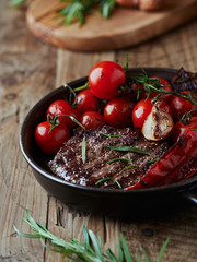 Grilled steak with vegetables in a pan
