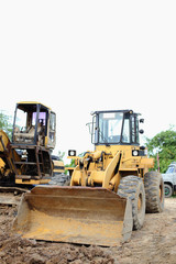 Fototapeta na wymiar loader Excavator with backhoe unloading sand at eathmoving works