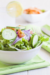fresh green salad with cucumber, tomato and red onion.