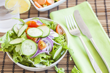 fresh green salad with cucumber, tomato and red onion.
