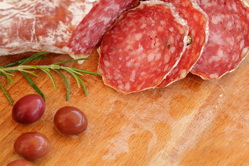 Italian food - salami, rosemary and olives