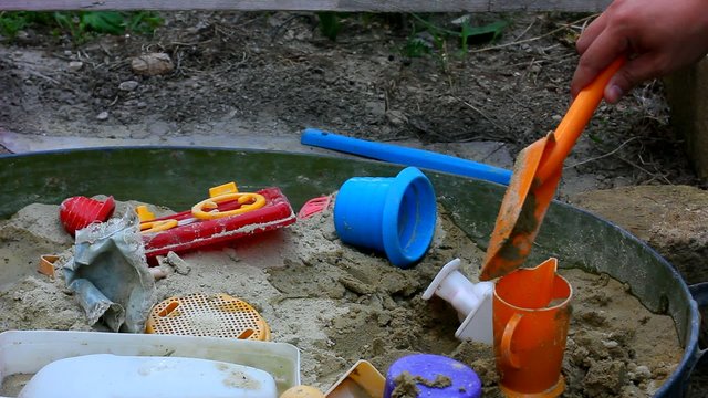 child playing in sandbox
