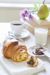 Croissants with chocolate, milk and coffee, delicious breakfast