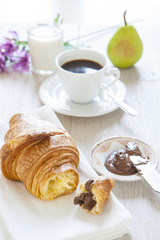 Croissants with chocolate, milk and coffee, delicious breakfast