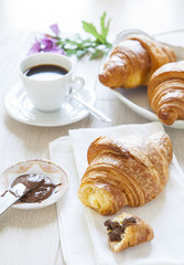 Croissants with chocolate, milk and coffee, delicious breakfast