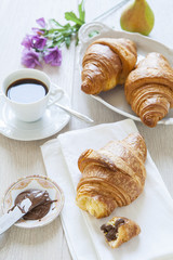 Croissants with chocolate, milk and coffee, delicious breakfast