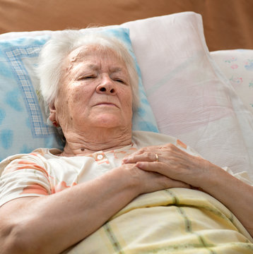 Senior woman lying at bed