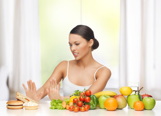 woman with fruits rejecting junk food
