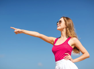 girl showing direction on the beach