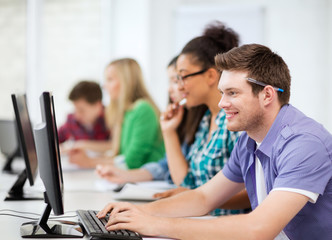 students with computers studying at school