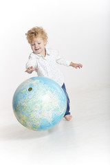 Happy young traveler holding the world