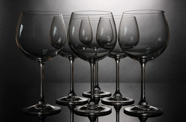 Empty wine glasses arranged on grey background