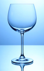 Empty wine glasses arranged on blue background