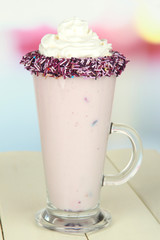 Delicious milk shake on table on light background