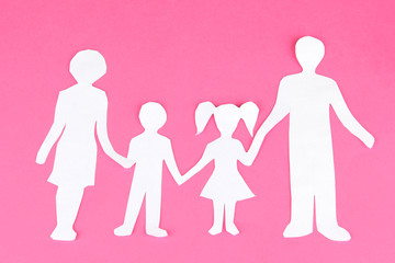 Family from paper on bright background