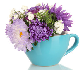 Beautiful bouquet of bright flowers in color mug, isolated