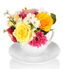 Beautiful bouquet of bright flowers in color mug, isolated