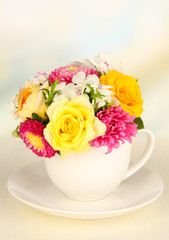Beautiful bouquet of bright flowers in color mug,