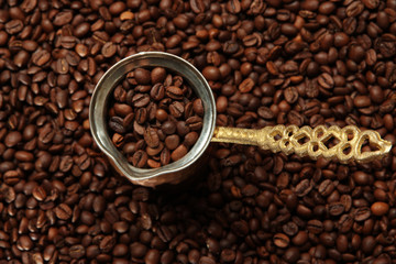 Metal turk on coffee beans background