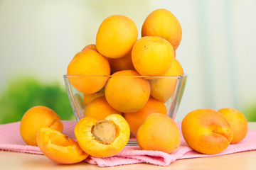 Fresh natural apricot in bowl on table in kitchen