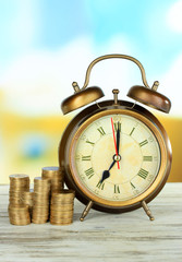 Alarm clock on table on bright background