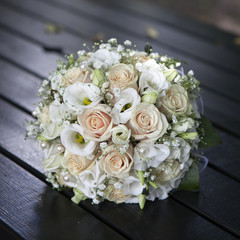 Wedding bouquet of yellow cream roses lying