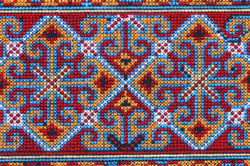 Cross stitch embroidery on canvas.