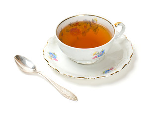 tea in vintage cup isolated on white