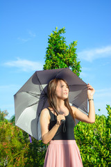 asia girl hold umbrella with face feel so hot