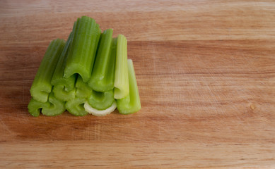 Pile of celery stalks on chopping board