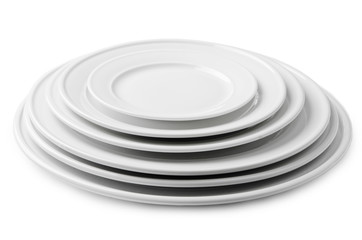 A stack of blank white plates of different sizes