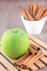 Green apple with cinnamon sticks