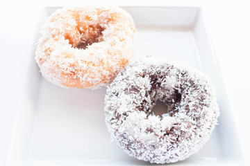 Chocolate and vanilla donuts with coconut cover