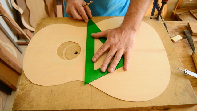 Luthier working on a guitar harmonica cover