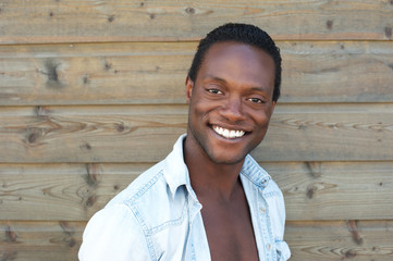 Obraz premium Portrait of a happy young man smiling outdoors