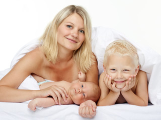 Mother, son and newborn under a blanket