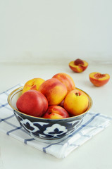 Ripe nectarines in oriental bowl