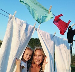 young girl hanging linen