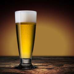 Glass of beer on wood table
