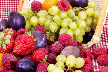 tasty summer fruits on a red tablecloth