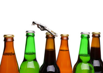 Top bottles of beer and a opener.