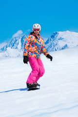 Fototapeta na wymiar Snowboarder sliding downhill