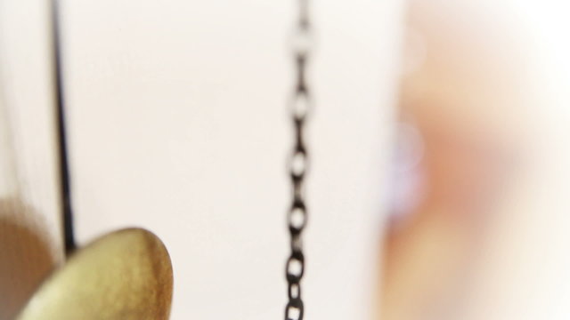 Pendulum of a grandfather clock swinging