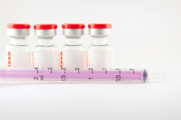 Purple disposable syringe and injection vials