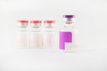 Purple label injection vial on blur vials background