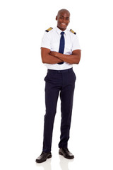 african airline captain with arms crossed