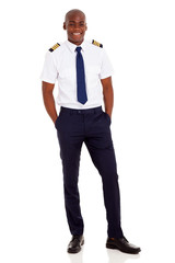 african airline pilot standing over white background