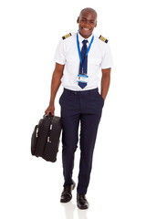 young airline pilot carrying briefcase © michaeljung