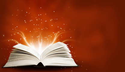 Opened magic book with magic light